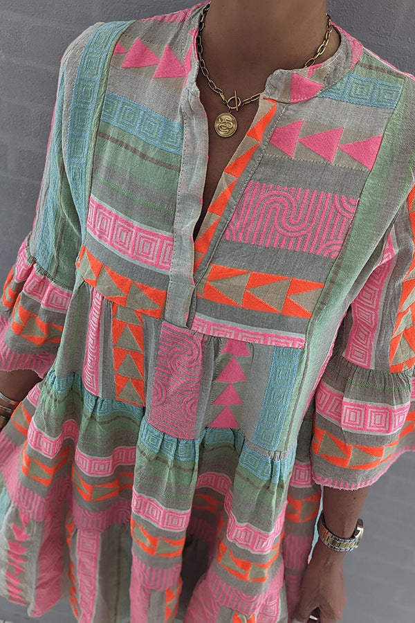 Women's patchwork summer dress torso close-up with V-neck and geometric print panels