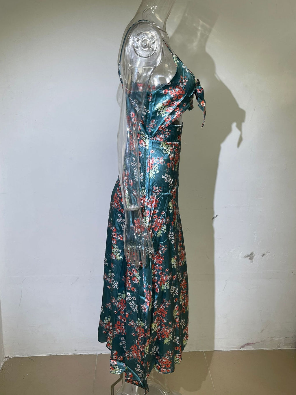 Teal floral georgette dress on mannequin with spaghetti straps and tie-front V-neck