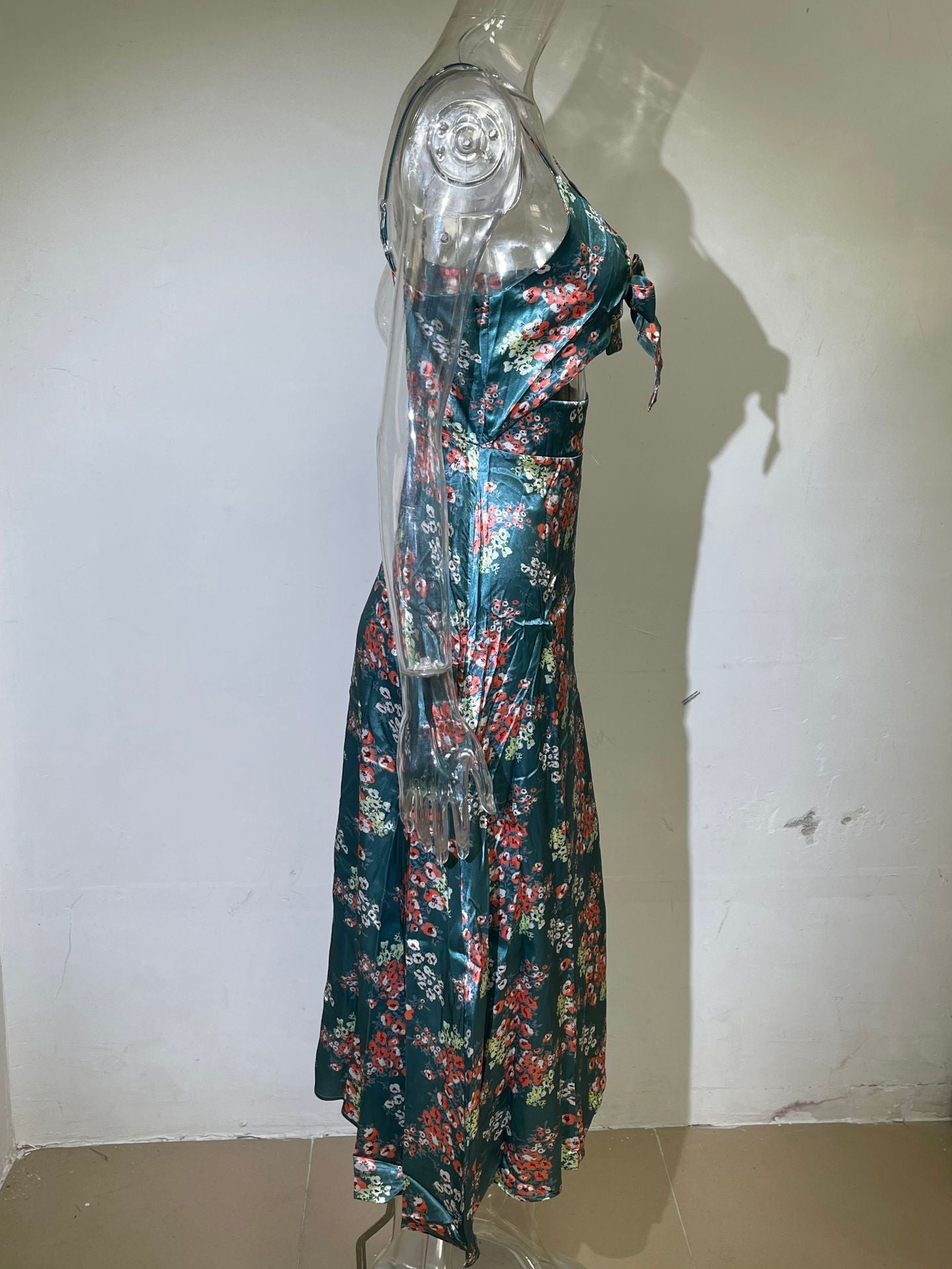 Teal floral georgette dress on mannequin with spaghetti straps and tie-front V-neck