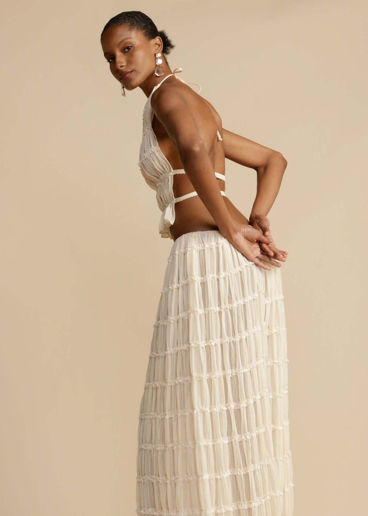 White halter crop top and tiered maxi skirt set, close side angle showing straps