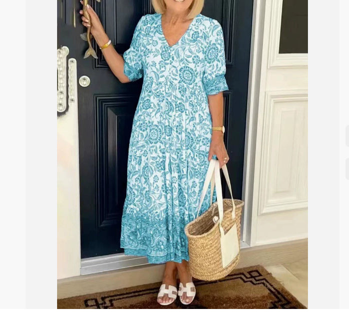 BRONYA V-neck midi dress in light teal floral print, short sleeves, tiered skirt.