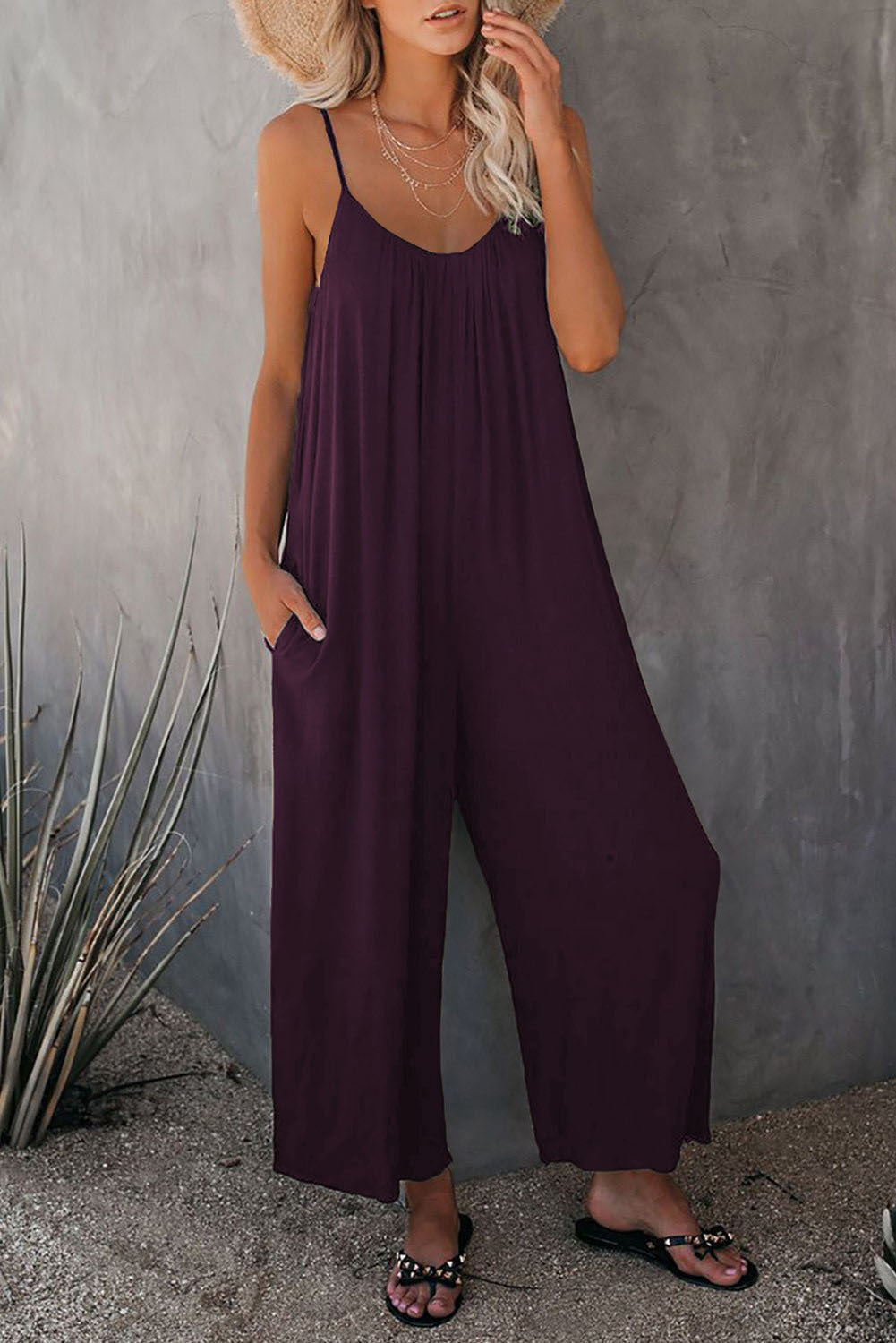 Purple loose jumpsuit with thin straps and wide-leg, relaxed fit.
