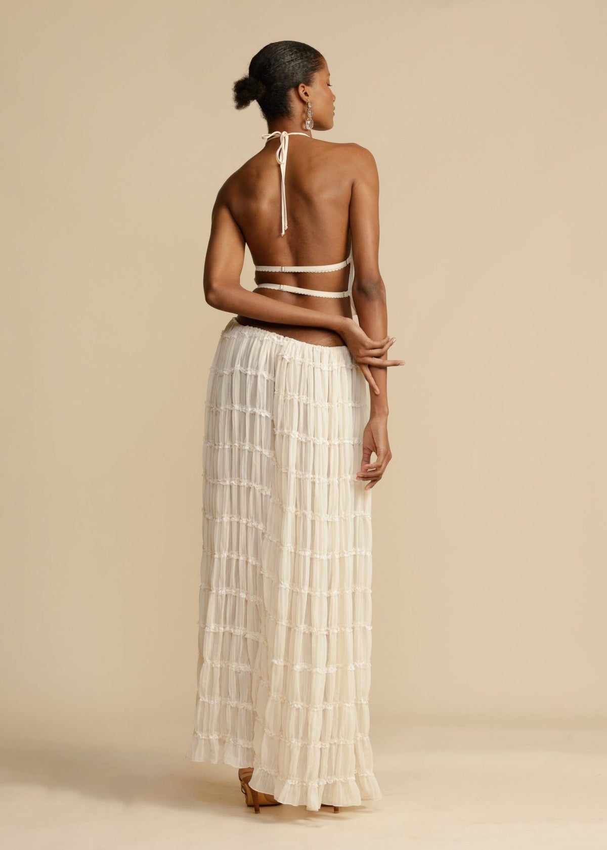 White tiered halter crop top and layered maxi skirt set, open back
