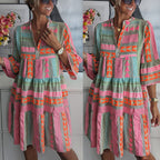 Two women wearing pink-and-teal patchwork summer dresses with V-neck and tiered hem