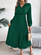 Green pleated midi dress with V-neck lace trim and long balloon sleeves, side view