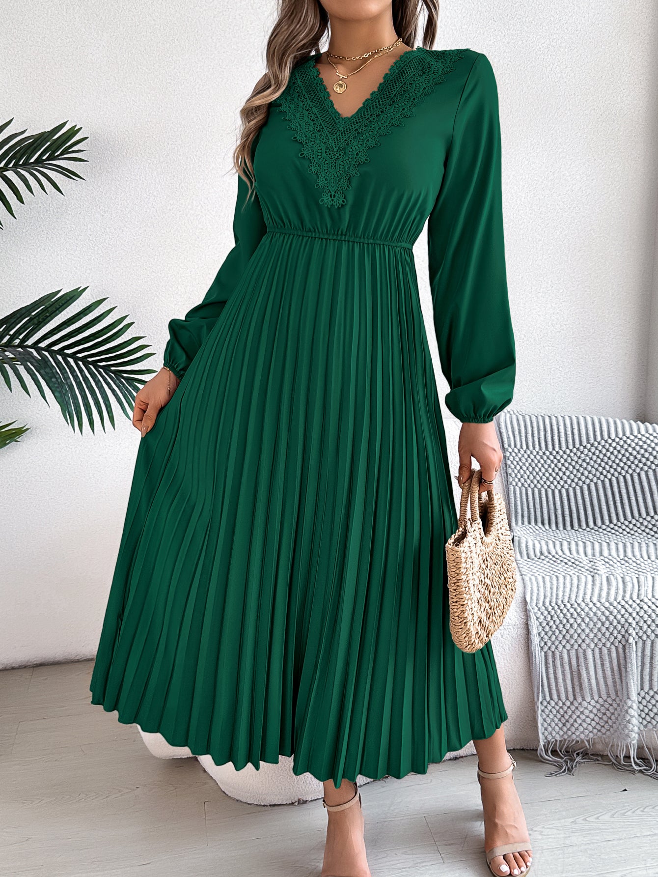 Green pleated midi dress with V-neck lace trim and long balloon sleeves, side view