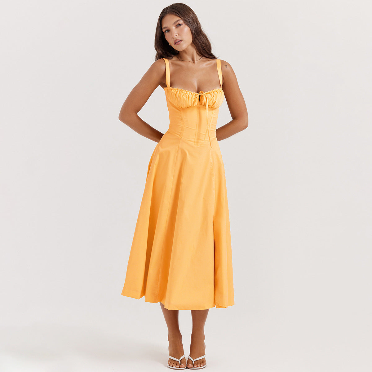 Elegant midi dress in orange with spaghetti straps and ruched bust