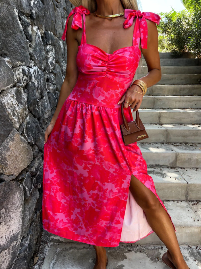 Bright pink floral summer dress with ruched sweetheart bodice, bow shoulder ties and slit