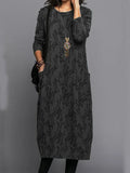 Stylish long black patterned dress with long sleeves and round neckline