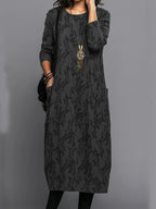Stylish long black patterned dress with long sleeves and round neckline
