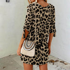 Leopard-print mini dress with round neck and tied-cuff three-quarter sleeves