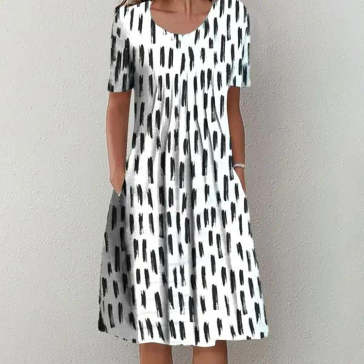 Casual white and black abstract print dress with short sleeves, round neckline, and midi length