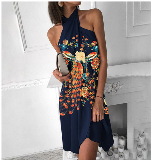 Navy halter dress with colorful peacock-style floral print and knee-length skirt