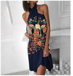 Navy halter dress with colorful peacock-style floral print and knee-length skirt