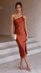 Brown satin midi slip dress with spaghetti straps and draped neckline.
