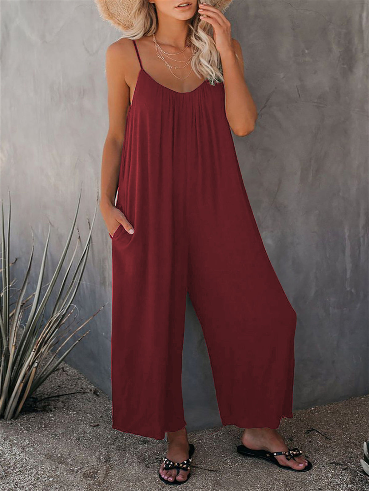 Dark red loose-fitting jumpsuit with spaghetti straps and wide-leg pants