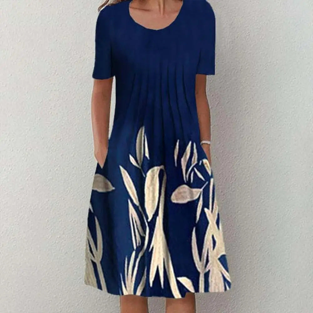 Casual floral dress in navy with cream leaf and floral pattern, short sleeves, and round neckline