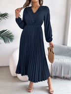 Pleated midi dress with long sleeves and lace-trim V-neck in navy blue, carrying bag