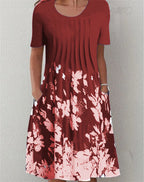 Casual floral dress in deep rust red with blush floral print, short sleeves, and round neckline