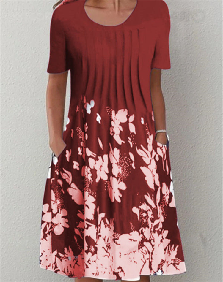 Casual floral dress in deep rust red with blush floral print, short sleeves, and round neckline