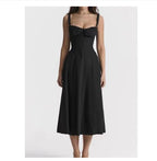 Black mid-length dress with spaghetti straps, smocked bust, and flared skirt