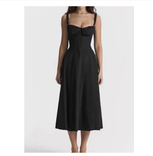 Black mid-length dress with spaghetti straps, smocked bust, and flared skirt