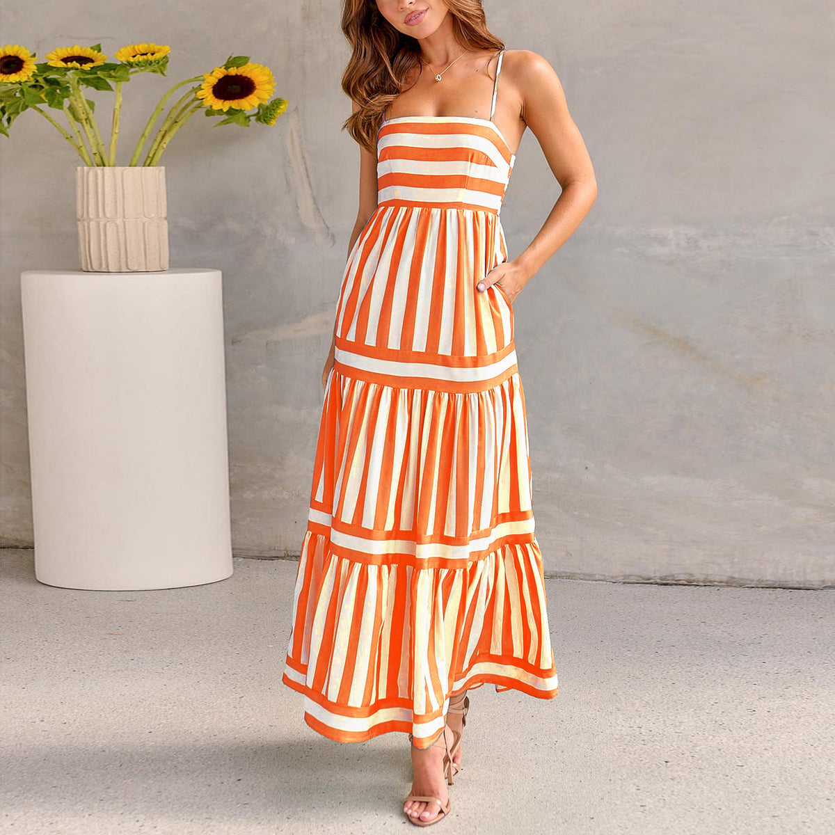 Orange striped tiered maxi dress with spaghetti straps and layered skirt