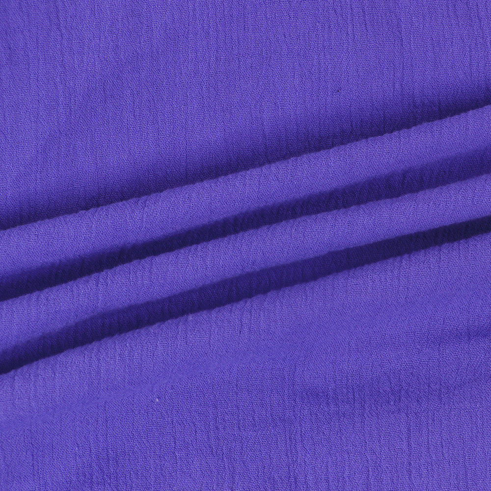 Purple textured fabric closeup with crinkle surface and soft drape