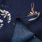 Navy fabric with white leaf print and stitched seam detail