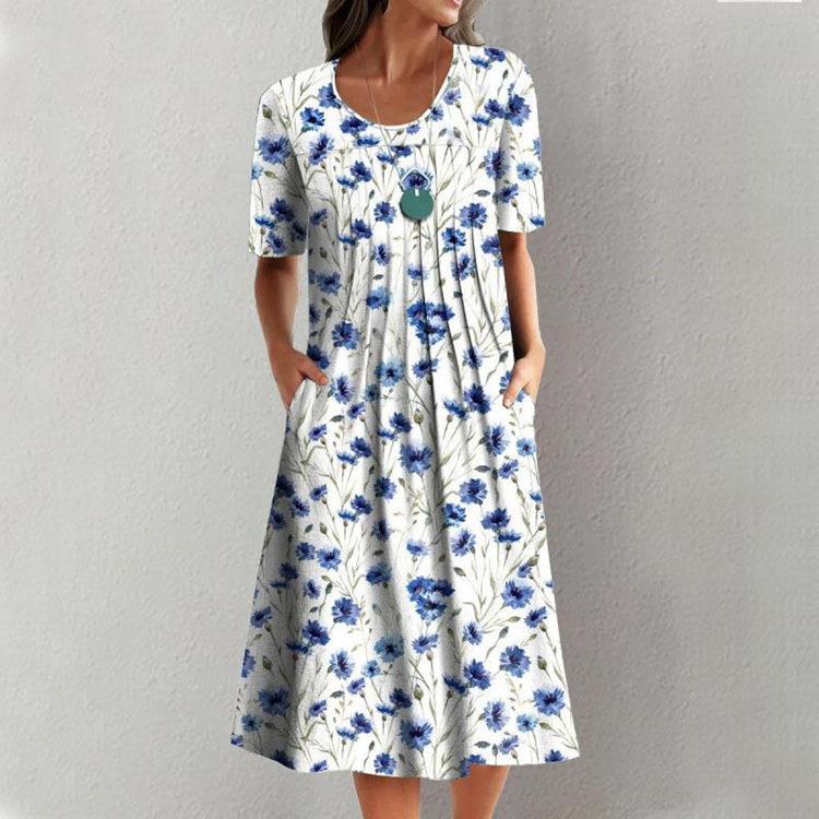Casual white dress with blue floral print, short sleeves, round neckline, and gathered skirt