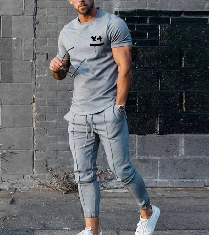 Light gray t-shirt with black chest graphic and jogger pants with front pockets
