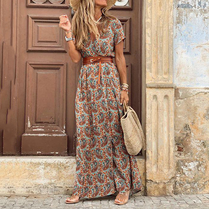Boho maxi dress in teal and blue paisley print with short sleeves, tied waist belt