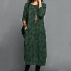 Stylish long green dress with abstract foliage pattern, long sleeves, round neckline