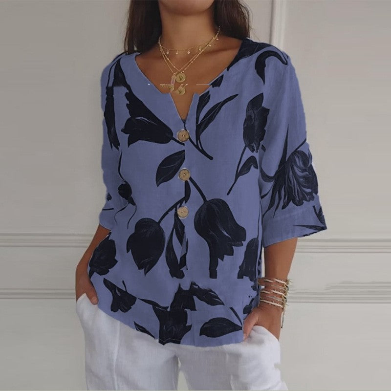 Light blue summer button-up shirt with dark blue floral leaf print, V-neck, 3/4 sleeves
