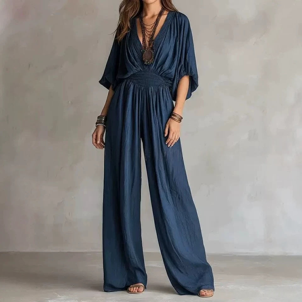 Dark-blue V-neck wide-leg jumpsuit with elastic waist and draped short sleeves