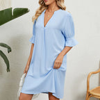 Light blue V-neck midi dress with puff sleeves and flared cuffs, relaxed drape