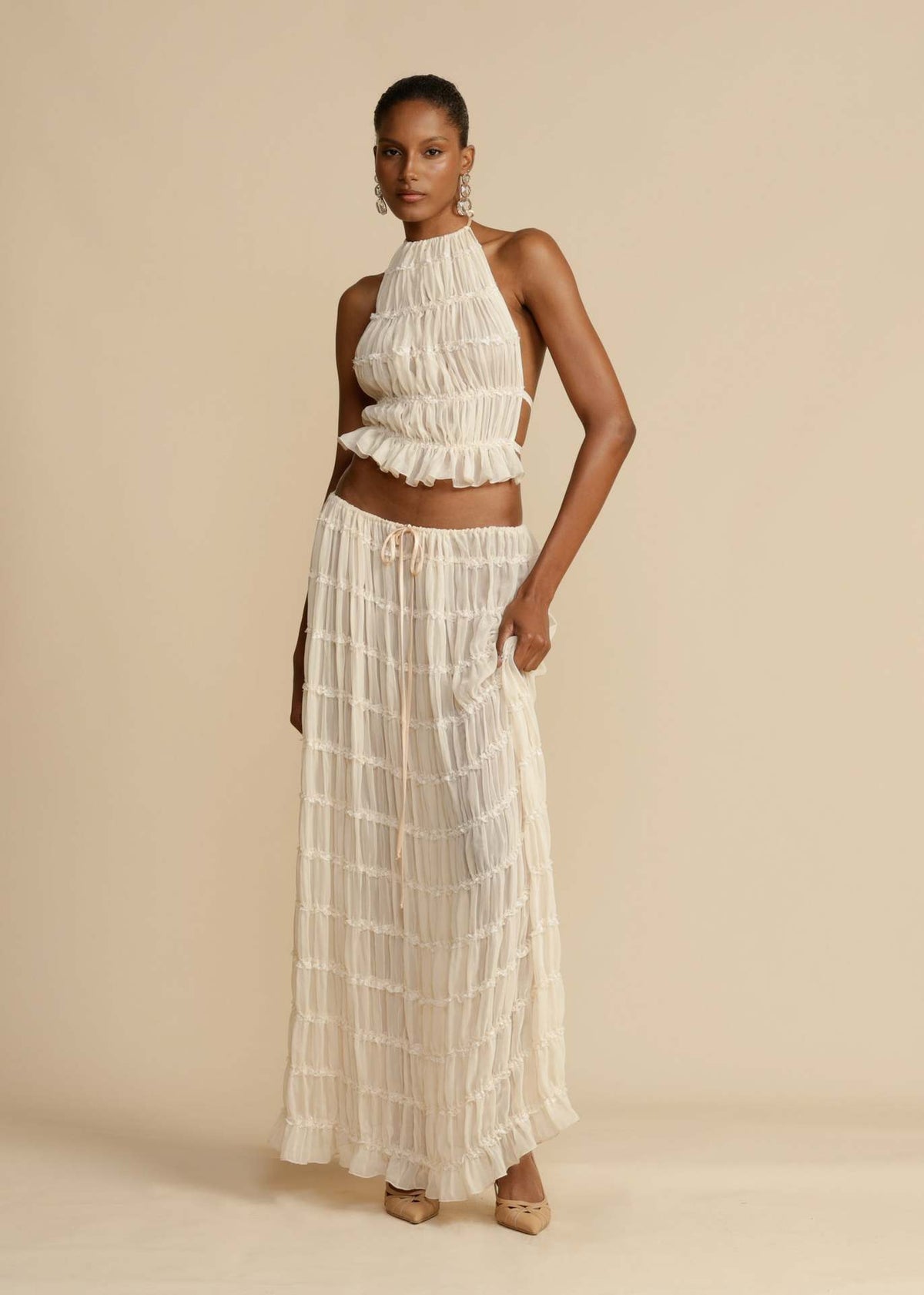 White halter top and tiered maxi skirt set, front three-quarter view