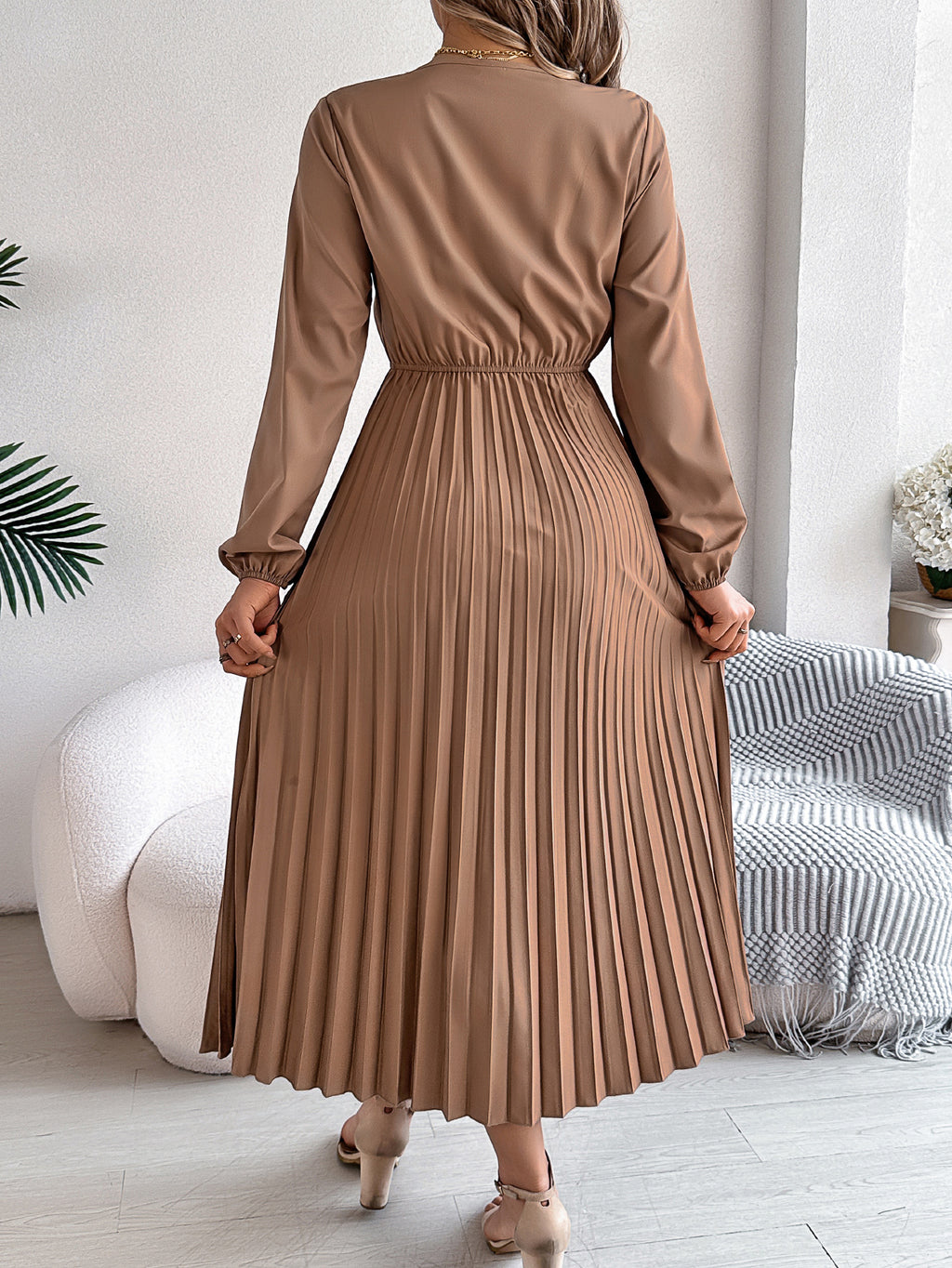 Pleated midi dress with long sleeves, V-back, and gathered waist in taupe