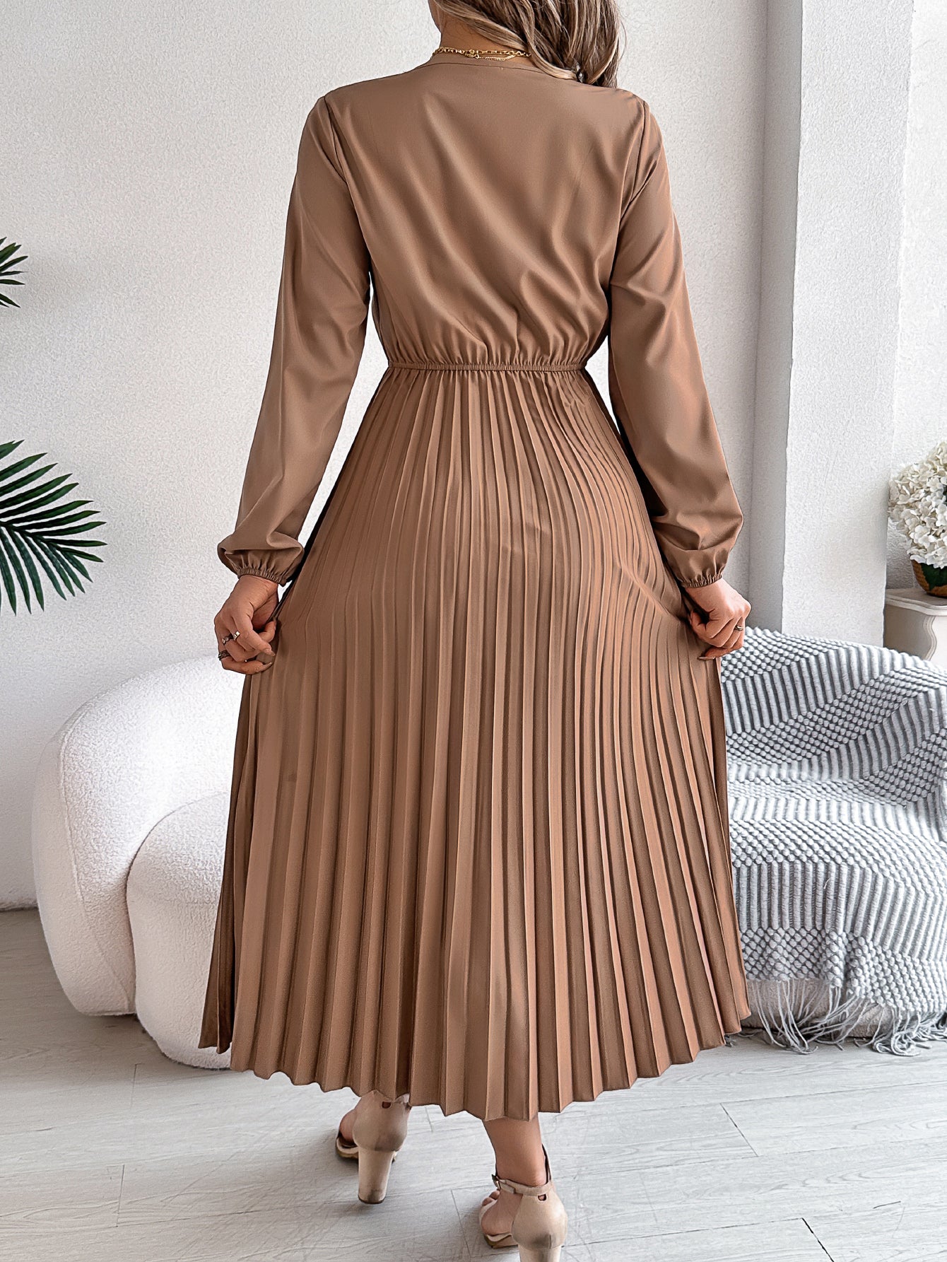 Pleated midi dress with long sleeves, V-back, and gathered waist in taupe