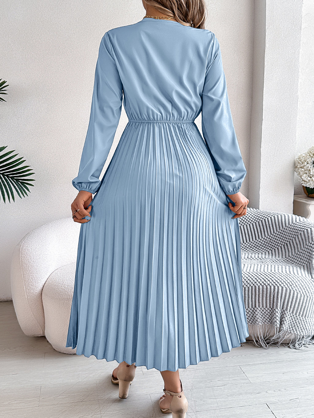 Light blue pleated midi dress with V-neck lace trim and long balloon sleeves, back view