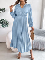 Light blue pleated midi dress with V-neck lace trim and long sleeves, belted waist