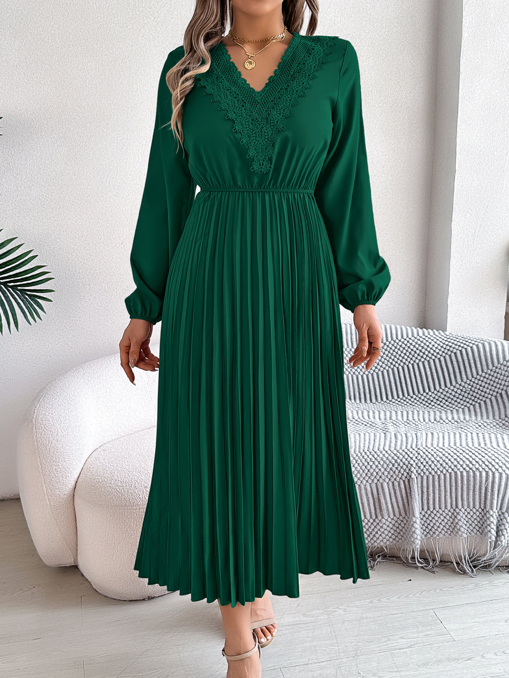 Green pleated midi dress with V-neck lace trim and long balloon sleeves