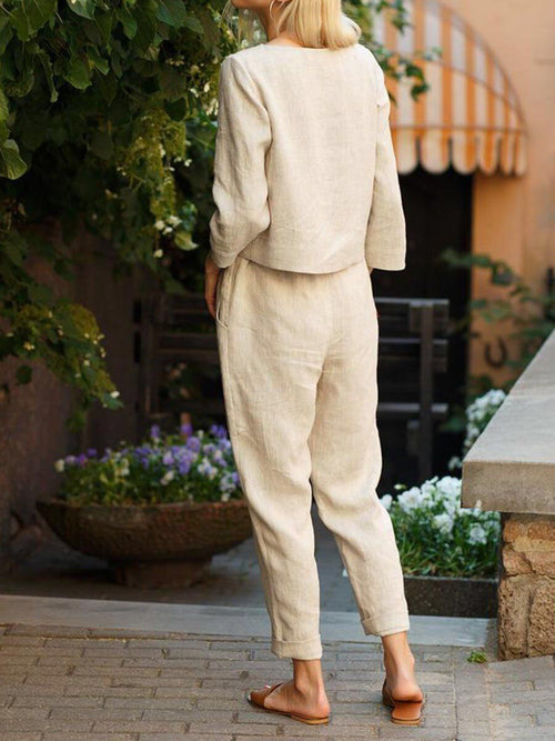 Relaxed two-piece set in beige: long-sleeve top and tapered drawstring pants.