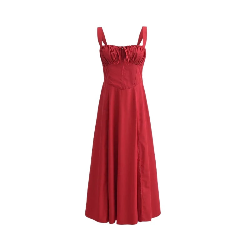 Red mid-length dress with spaghetti straps, gathered bodice, and pleated flared skirt