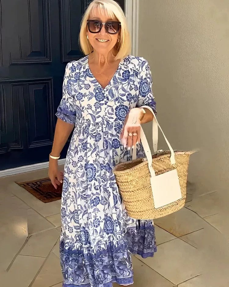 BRONYA V-neck midi dress in blue floral print, short sleeves, tiered skirt.
