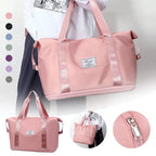 Pink duffel bag with long handles, stitched trim, front patch label, and top zip.