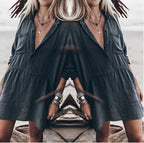 Relaxed loose dress, dark V-neck button-front with short puff sleeves and layered skirt