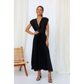 Black pleated maxi dress with V-neck, gathered waist, and short puff sleeves