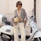 Clara™ elegant blouse, black-and-white striped V-neck with long sleeves and buttons