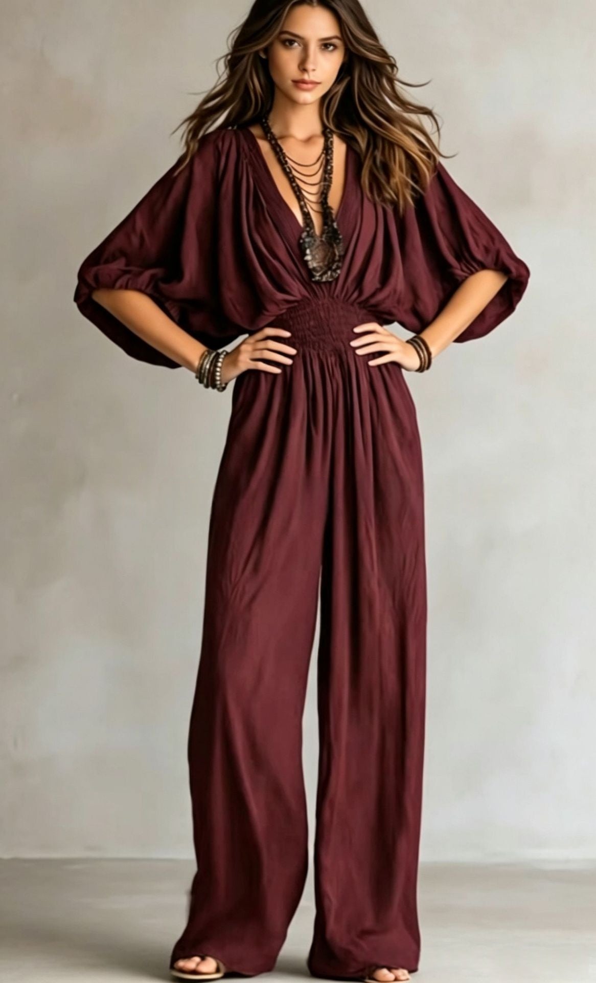 Burgundy V-neck wide-leg jumpsuit with elastic waist and draped short sleeves